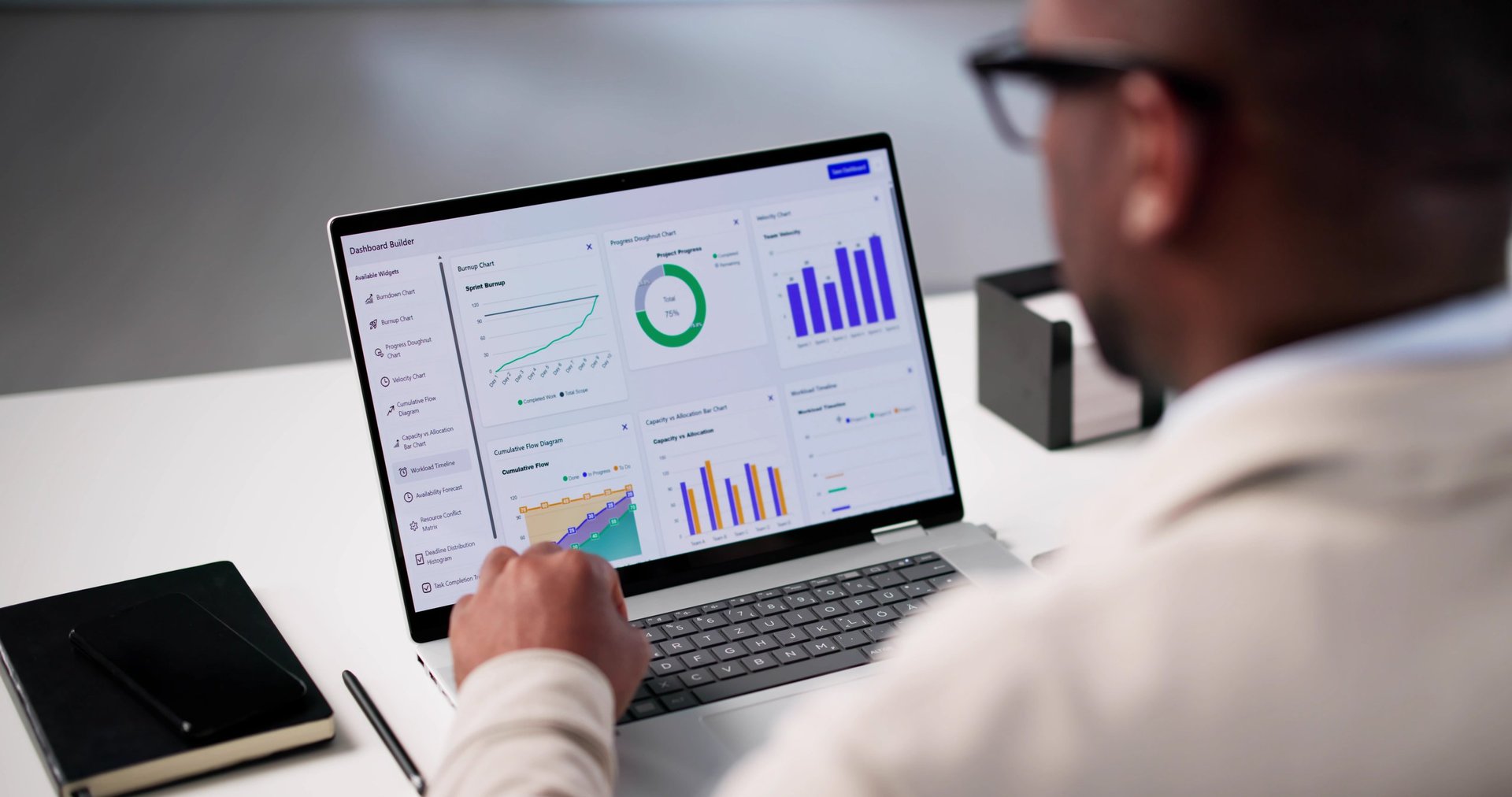 Professional data analyst reviewing performance metrics and KPIs in bright workspace