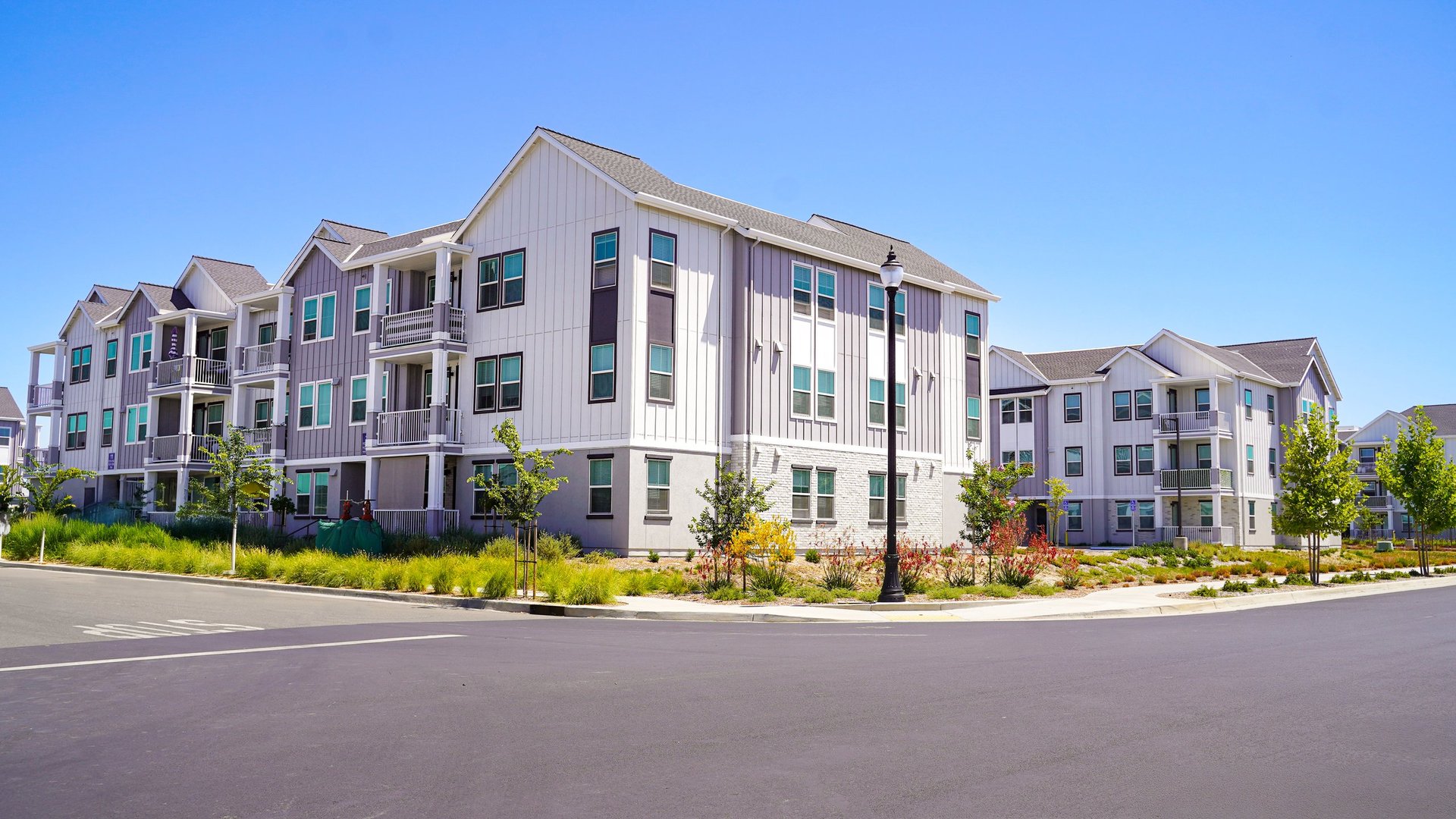 Clean apartment building with natural daylight representing stable housing environments